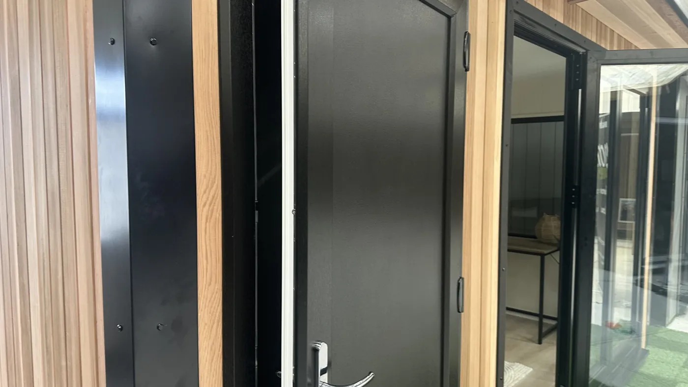 Composite door beside cedar cladding on a Noah garden room