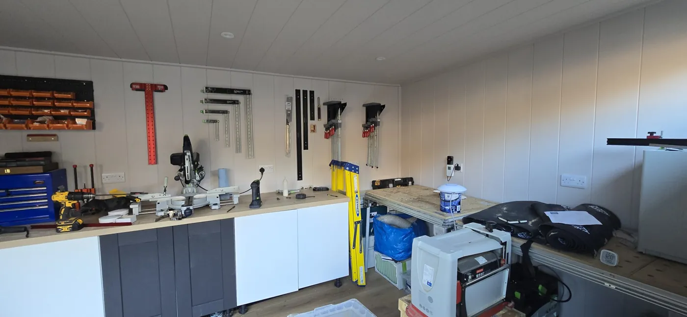 Workbench, tools and wall storage inside the Telford garden workshop