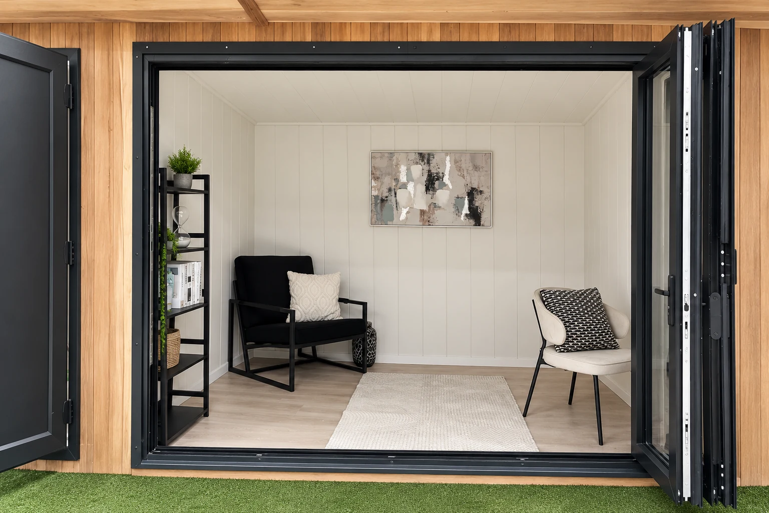 Showroom display room with an armchair, shelving and artwork seen through open doors