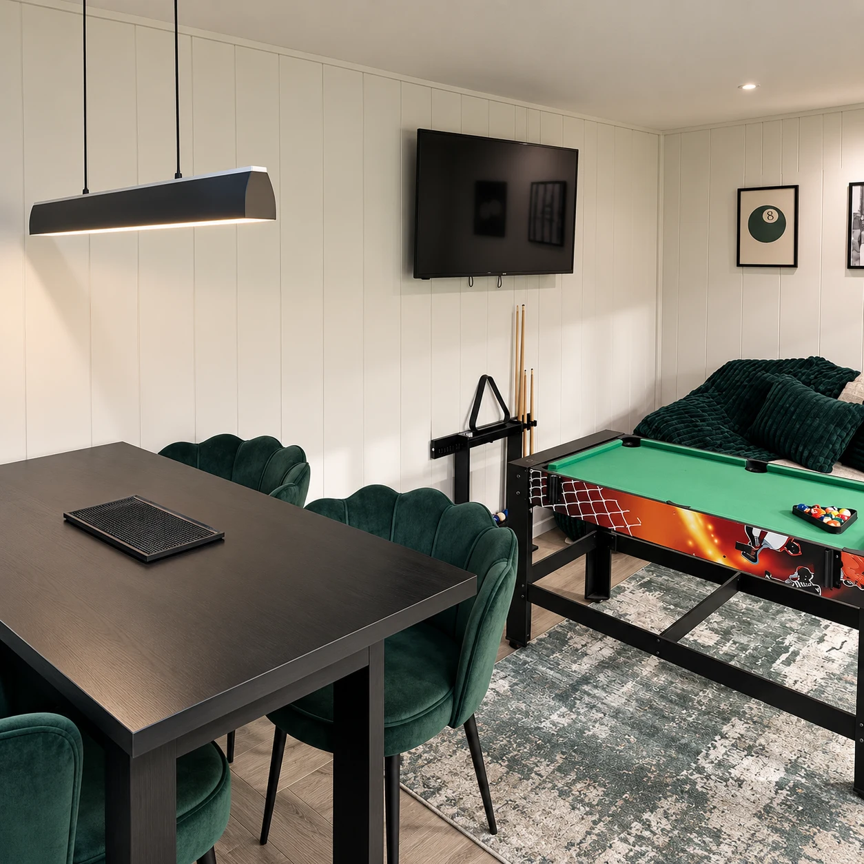 Showroom games room display with a pool table, dining table and television