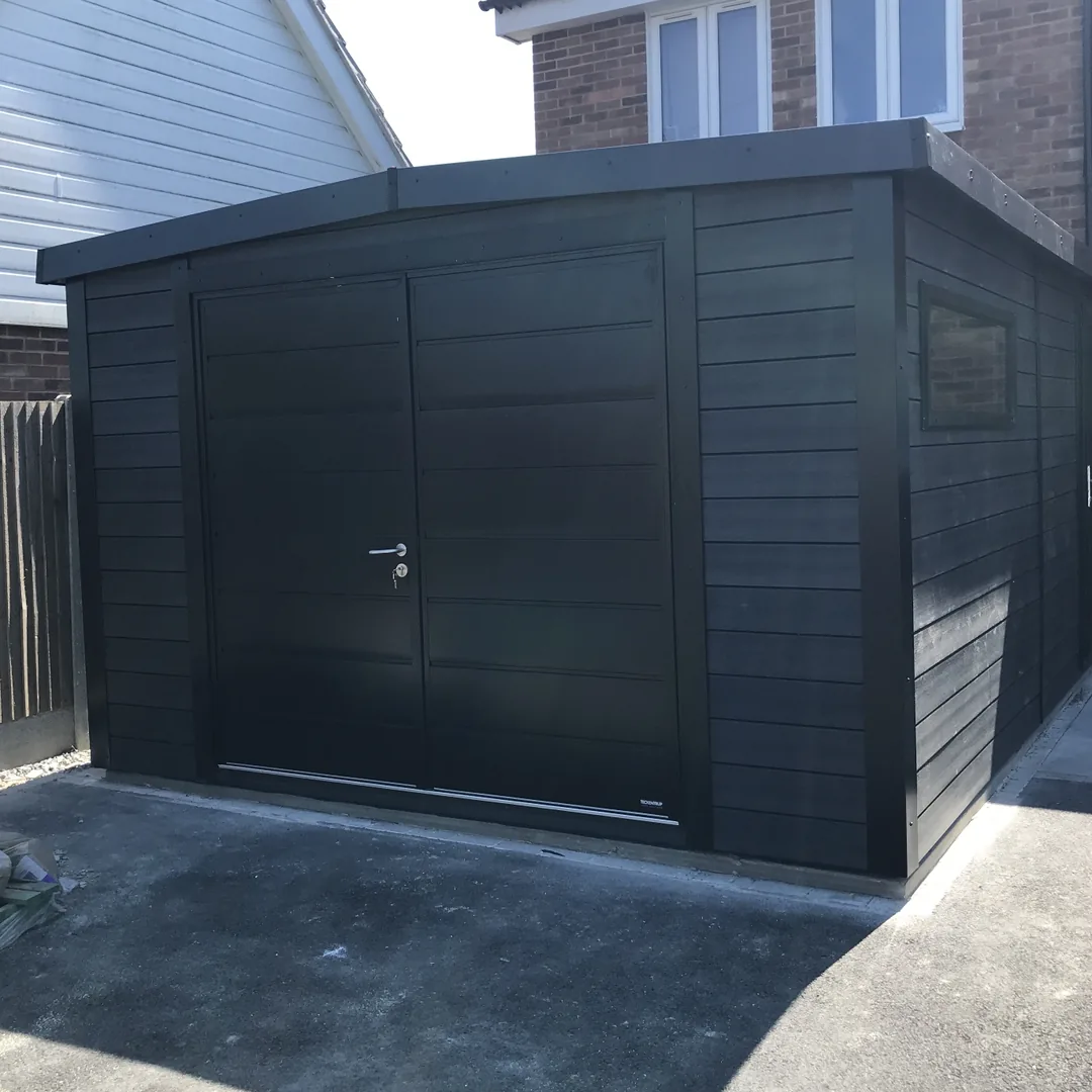 Black composite Noah garage with insulated metal double doors on a driveway
